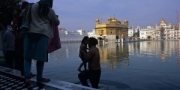 Morning bath of a sikh father and his son at the Golden Temple, Amritsar, India, 2010